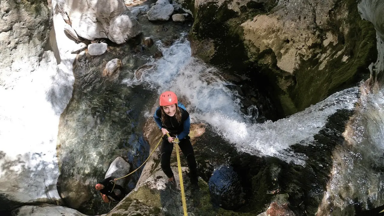 Canyoner abseiling beside a waterfall in Hrčavka